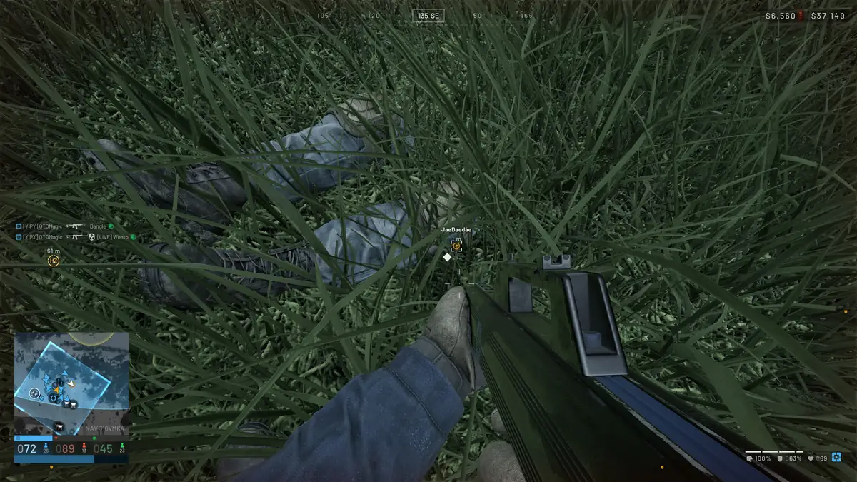Prone in the grass beside a body